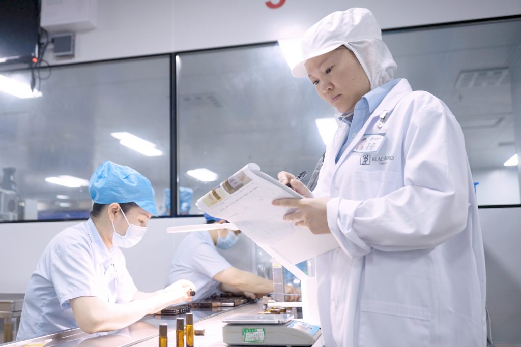 Blackbird Skincare quality-control team inspecting products in a manufacturing facility